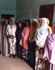 A group of women coffee producers in a blue room, in Limmu Ethiopia, part of the Atnago's womens coop