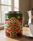 A view of Swelter Coffee's Limited Edition tin on a kitchen counter next to a cup of coffee by a sunny window.