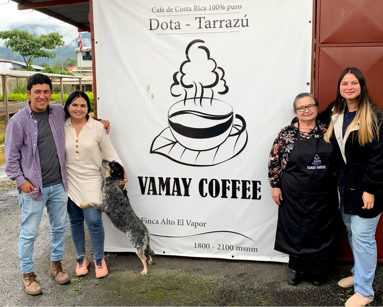 The Solis family with Mayra in front of their sign on their property in Costa Rica