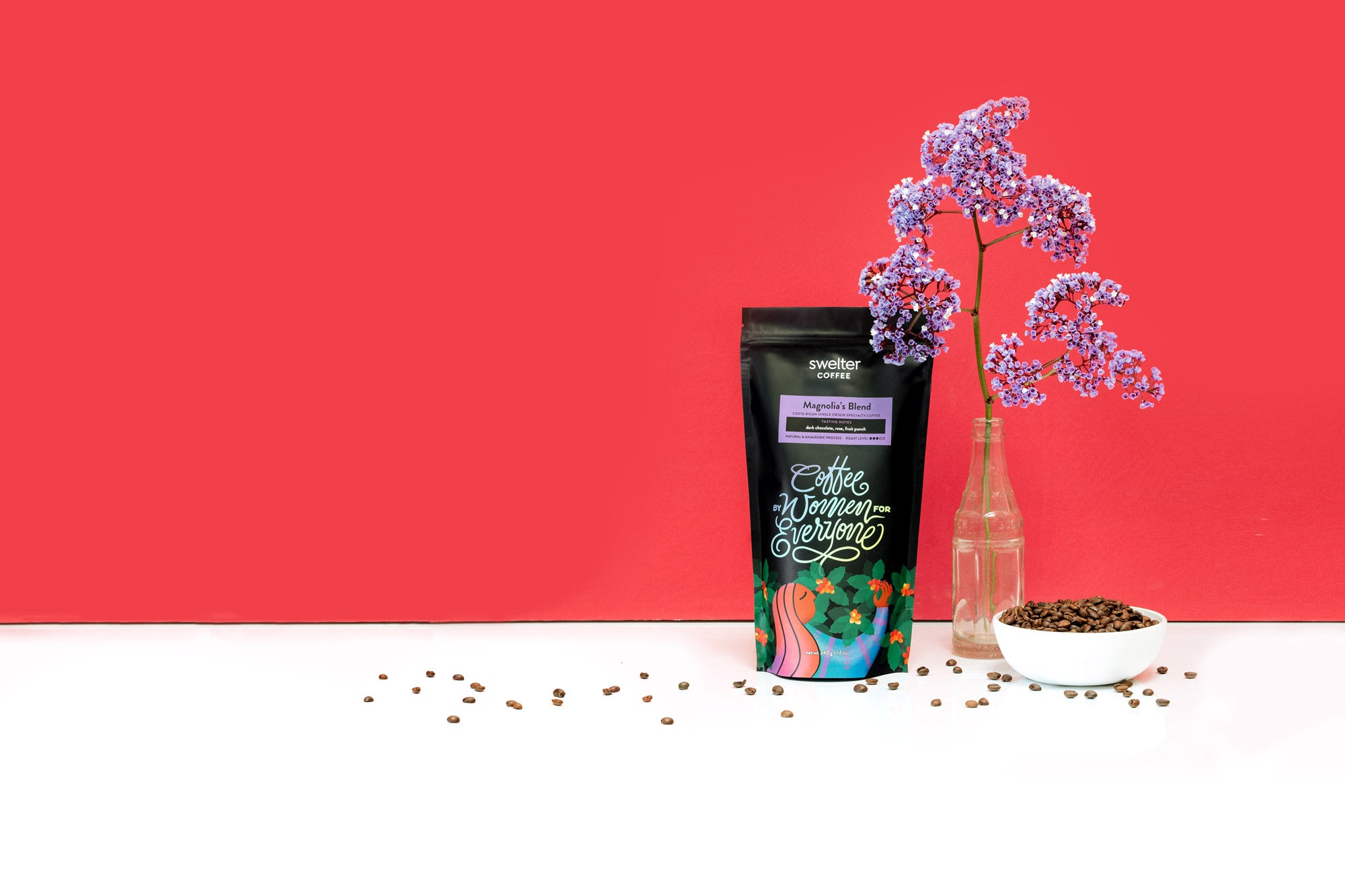 A Swelter Coffee bag with ethically sourced single origin coffee from Costa Rica beside decorative elements on a bright magenta background